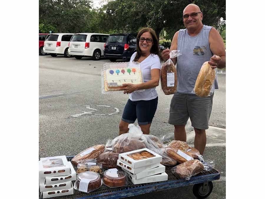 Man and Woman distributing baked goods